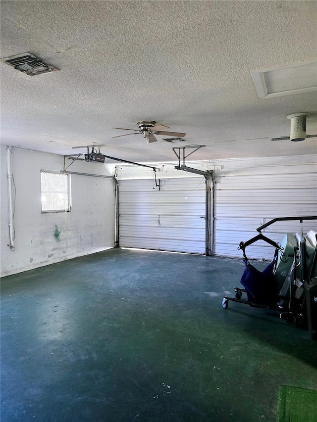 garage with a garage door opener and ceiling fan