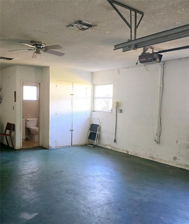 garage featuring a garage door opener and ceiling fan