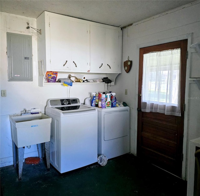 washroom featuring cabinets, separate washer and dryer, sink, and electric panel