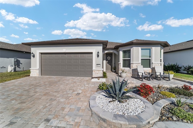 prairie-style house featuring a patio area and a garage