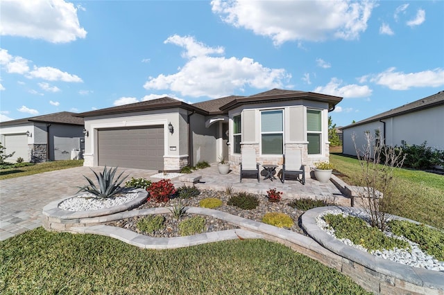 prairie-style home with a garage and a front yard