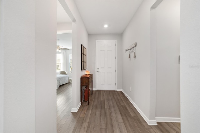 corridor with hardwood / wood-style flooring