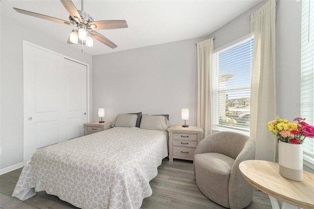 bedroom with ceiling fan, a closet, and light hardwood / wood-style floors