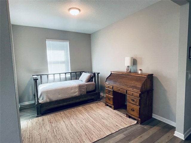 bedroom featuring dark hardwood / wood-style flooring