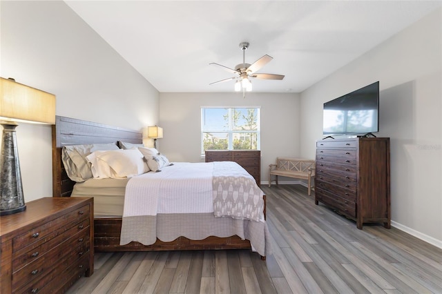 bedroom with ceiling fan and hardwood / wood-style flooring