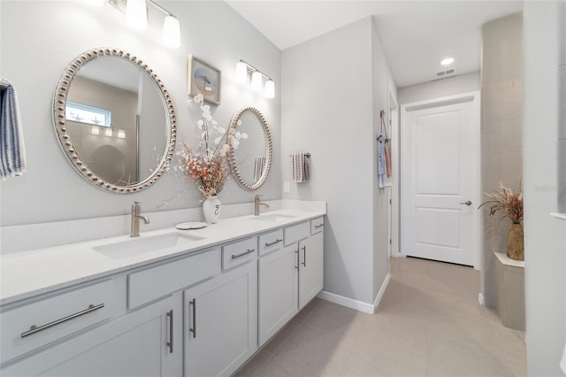 bathroom featuring tile patterned flooring and vanity