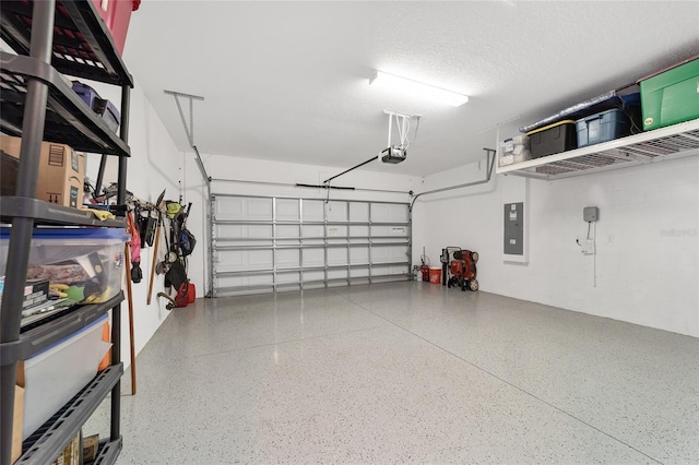 garage with electric panel and a garage door opener