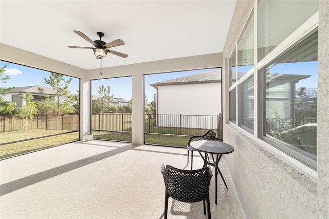 sunroom / solarium with ceiling fan and a wealth of natural light