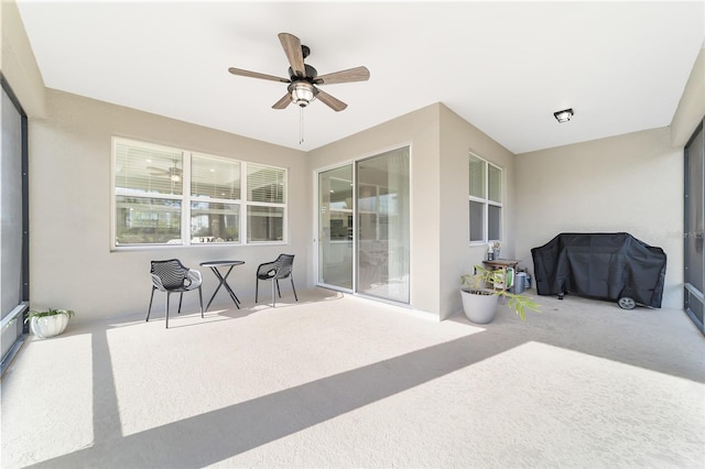 sunroom featuring ceiling fan