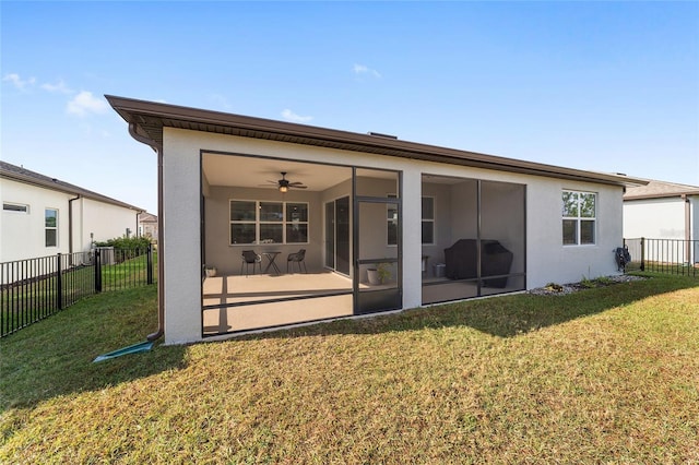 rear view of property with a sunroom and a yard