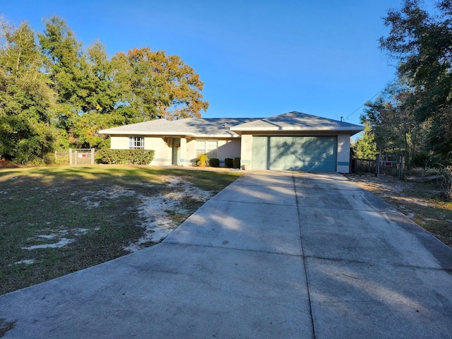 ranch-style house featuring a front lawn and a garage