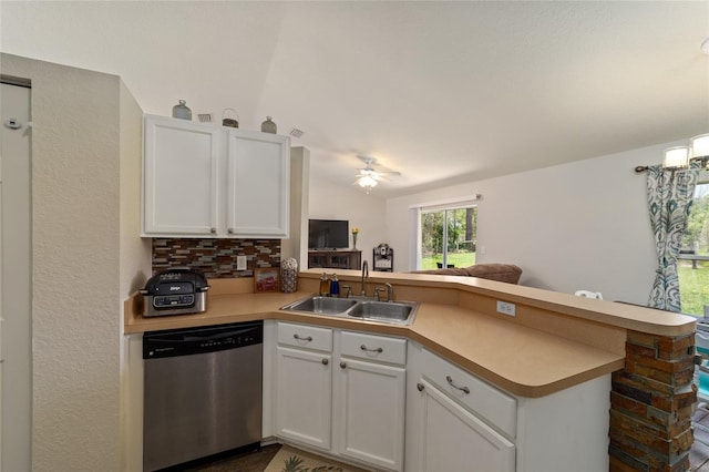 kitchen featuring kitchen peninsula, sink, white cabinets, and stainless steel dishwasher