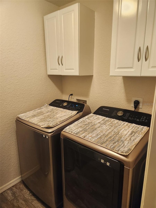 113 Guava Ter, Ocklawaha, FL 32179 - washroom featuring washing machine and clothes dryer, cabinet space, a textured wall, and baseboards