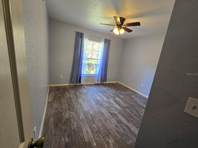 113 Guava Ter, Ocklawaha, FL 32179 - unfurnished room with dark wood finished floors, a textured wall, a ceiling fan, baseboards, and a textured ceiling
