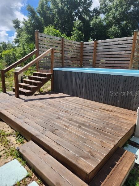 113 Guava Ter, Ocklawaha, FL 32179 - wooden deck with stairway