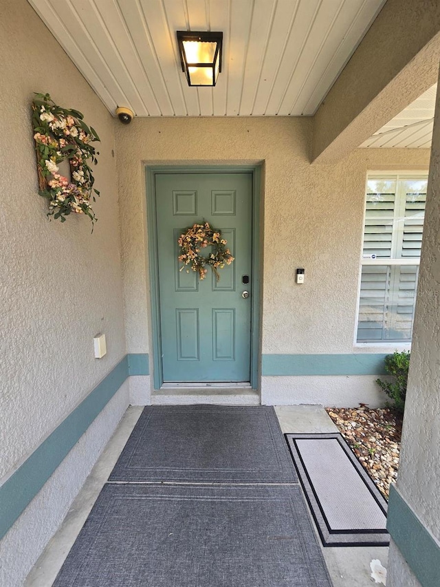 113 Guava Ter, Ocklawaha, FL 32179 - property entrance featuring stucco siding and a surveillance system