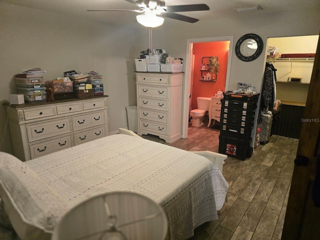 113 Guava Ter, Ocklawaha, FL 32179 - bedroom featuring dark wood-style flooring, a spacious closet, ensuite bath, and ceiling fan