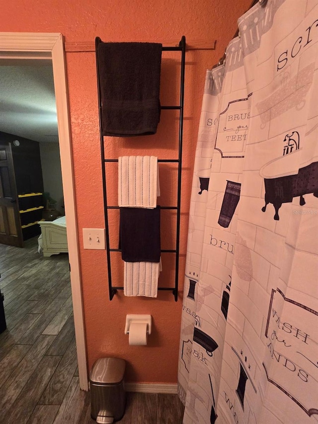113 Guava Ter, Ocklawaha, FL 32179 - bathroom with a shower with shower curtain and wood finished floors