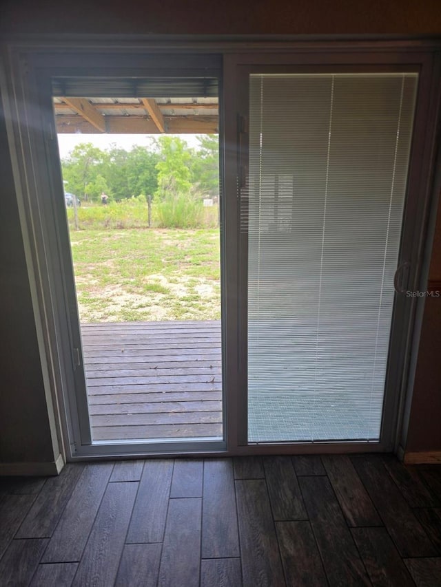 113 Guava Ter, Ocklawaha, FL 32179 - doorway to outside featuring dark wood-style flooring and baseboards