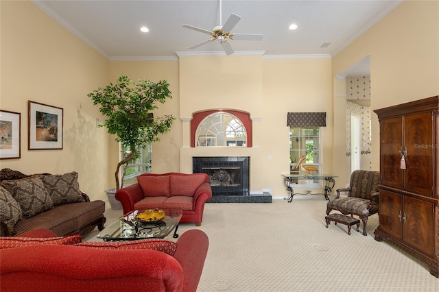 living room with a fireplace, carpet floors, ceiling fan, and crown molding