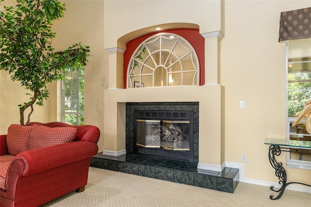 interior space with a high end fireplace and carpet flooring