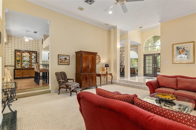 living room featuring carpet flooring, ceiling fan, crown molding, and french doors