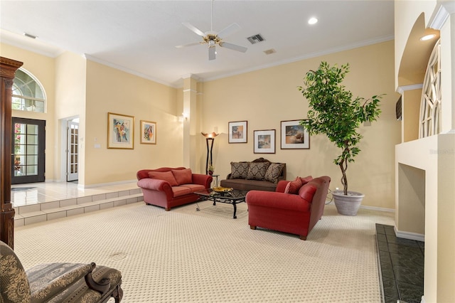 living room with carpet flooring, ceiling fan, and ornamental molding