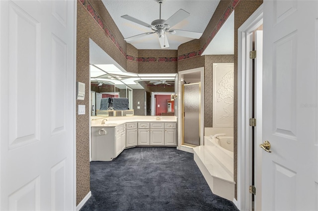 bathroom with ceiling fan, vanity, and independent shower and bath