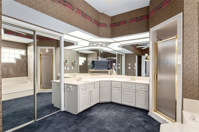 bathroom with ceiling fan, vanity, and an enclosed shower