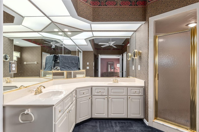 bathroom with vanity, ceiling fan, and a shower with shower door