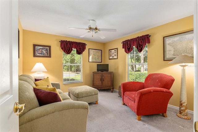 carpeted living room featuring ceiling fan