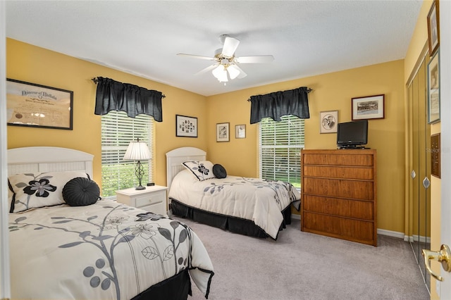 bedroom with ceiling fan and light colored carpet