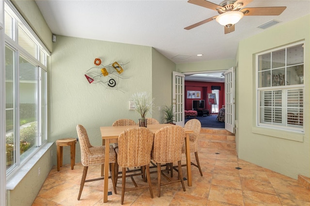 dining room with ceiling fan and french doors