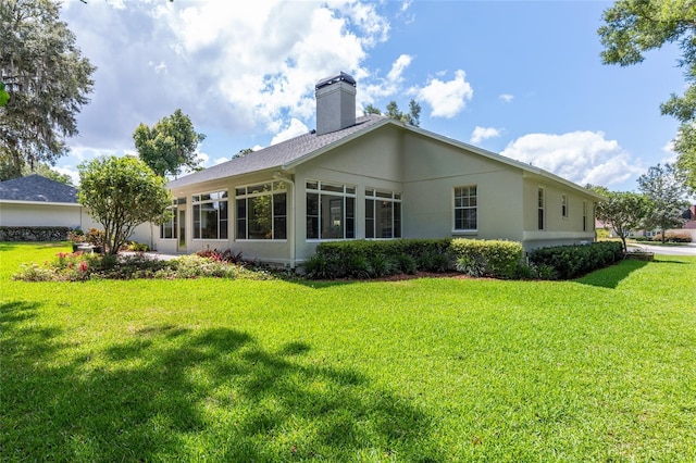 back of property featuring a yard