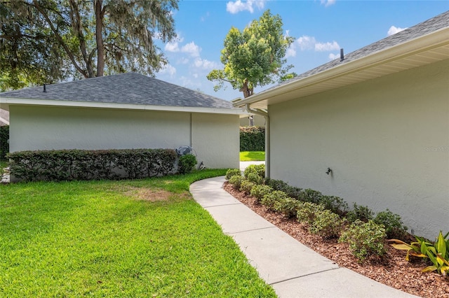 view of side of home with a lawn