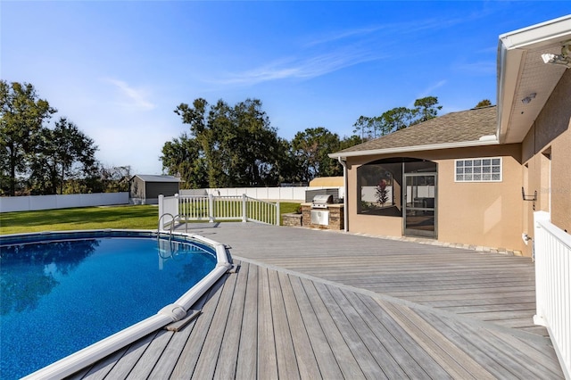 view of pool featuring a lawn and a wooden deck