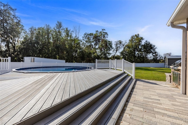 exterior space featuring a lawn and a covered pool