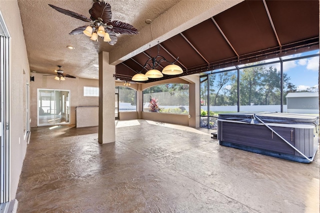 unfurnished sunroom with ceiling fan