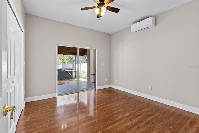 unfurnished room featuring hardwood / wood-style flooring, ceiling fan, and a wall unit AC