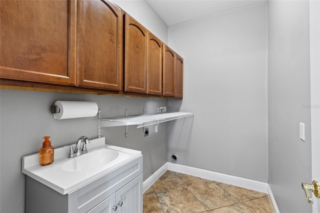 washroom with hookup for an electric dryer, cabinets, sink, and washer hookup