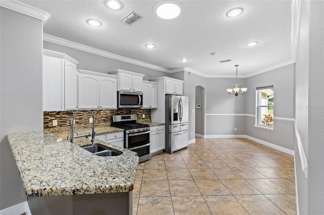 kitchen featuring white cabinetry, sink, stainless steel appliances, crown molding, and decorative backsplash