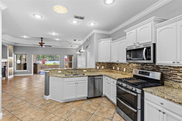 kitchen featuring kitchen peninsula, white cabinetry, sink, and appliances with stainless steel finishes