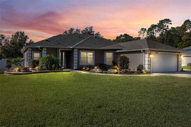 view of front facade featuring a garage and a lawn