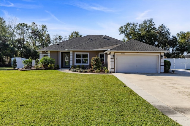 ranch-style house featuring a garage and a front lawn