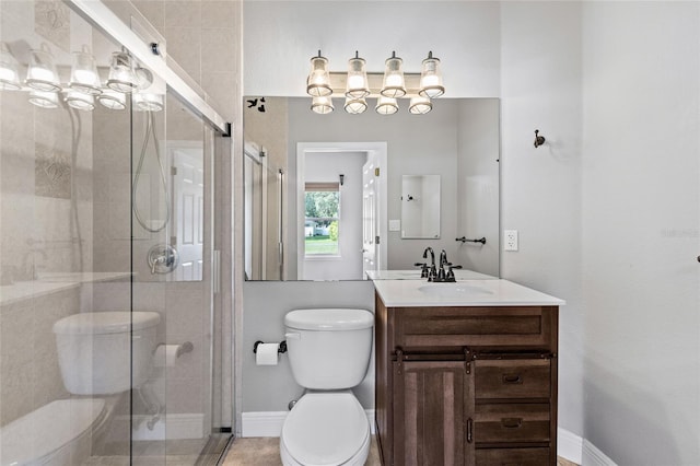 bathroom with vanity, toilet, and walk in shower