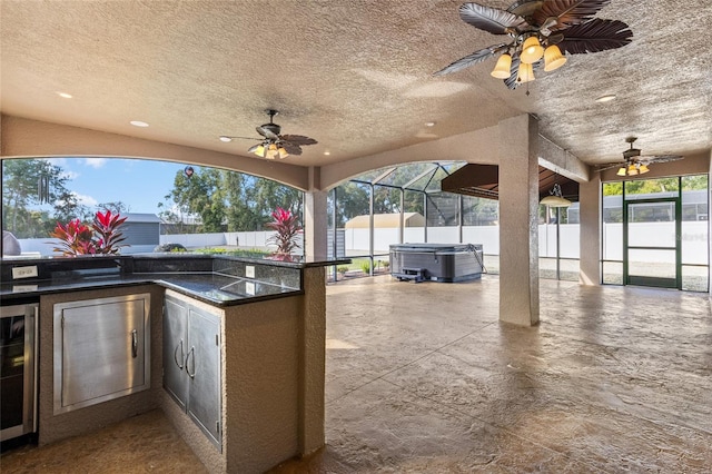 view of patio / terrace featuring wine cooler, area for grilling, exterior bar, and a hot tub