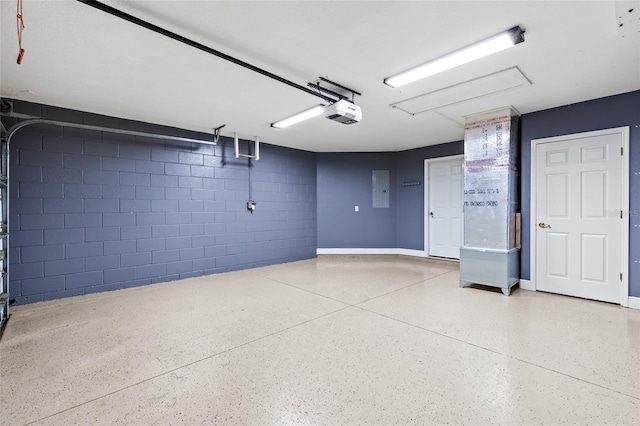 garage featuring electric panel and a garage door opener