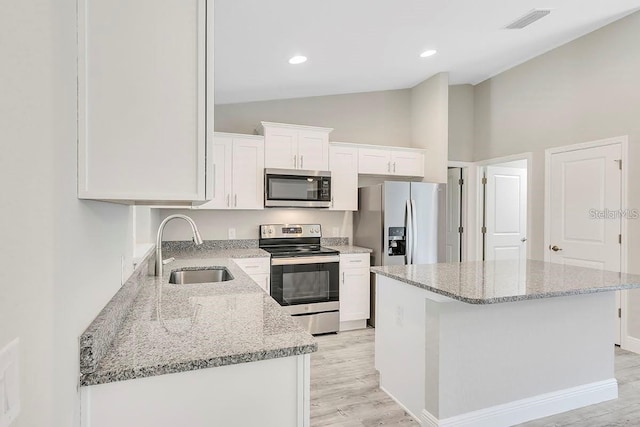 kitchen featuring white cabinets, light stone countertops, sink, and appliances with stainless steel finishes