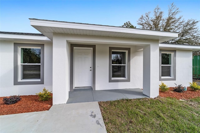 view of exterior entry with covered porch