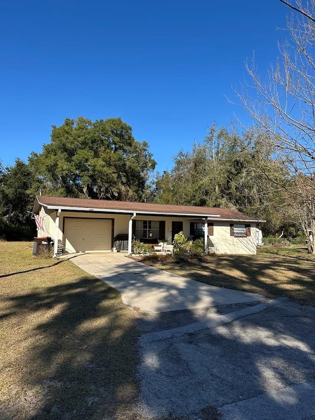 ranch-style house with a front lawn, a porch, and a garage